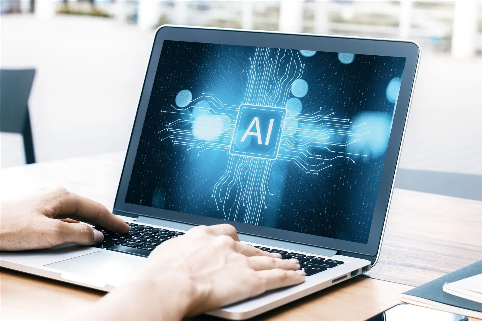 Hände tippen auf Laptop mit KI-Symbol – Symbolbild für Websites in KI-Antworten